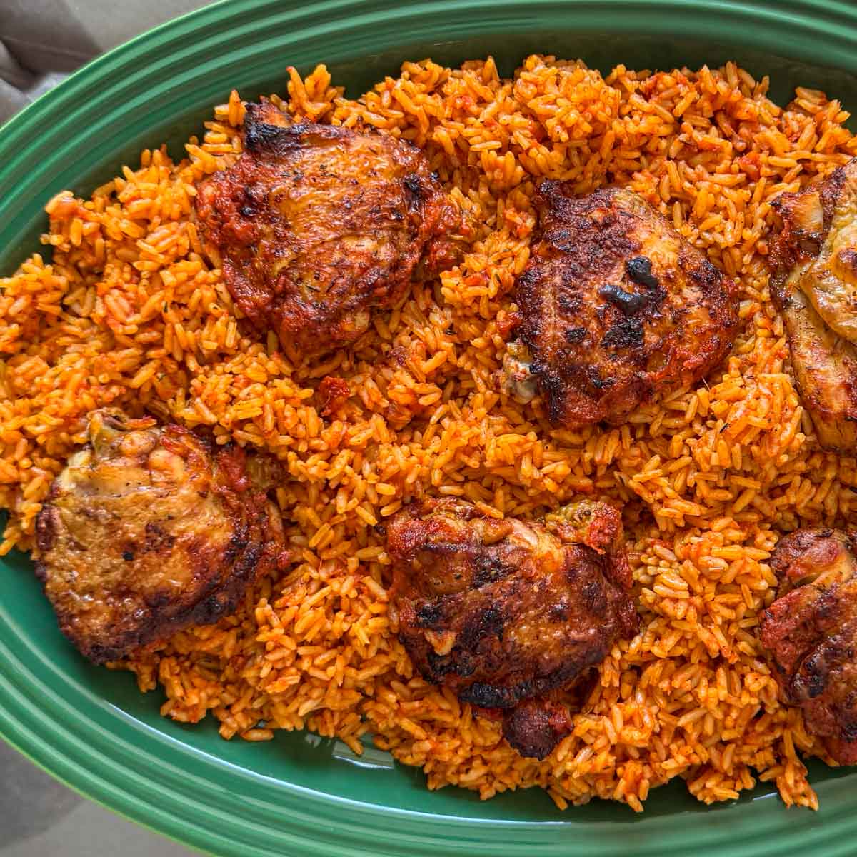 An image of a finished, well cooked and garnished serving of jollof rice